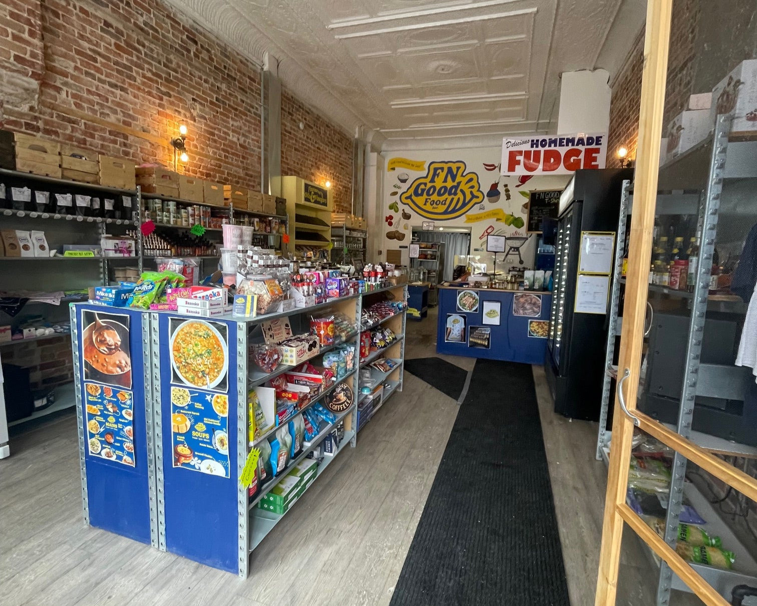 A photo of a well lit entry way of the store that showcases the many products and grocery items available